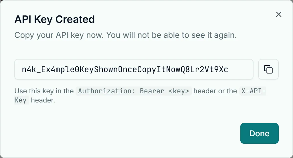 API Key Created dialog in Account Settings, API & Webhooks tab: the full key, shown only once, with a copy button.